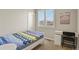 Well-lit bedroom with a comfortable bed, a study desk, and plantation shutters at 4205 E Iliff Ave # 5, Denver, CO 80222