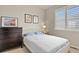 Sun-filled bedroom with a large window, modern dresser, and calming decor at 4205 E Iliff Ave # 5, Denver, CO 80222