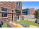 An artificial lawn backyard with an orange lounge set and an outdoor grill, is ideal for relaxing at 105 Fillmore St # 209, Denver, CO 80206