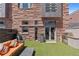 Backyard featuring artificial lawn, an orange lounge set, and a BBQ grill at 105 Fillmore St # 209, Denver, CO 80206