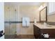 Bathroom with tiled shower, vanity, and dark wood accents at 105 Fillmore St # 209, Denver, CO 80206