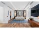 Spacious main bedroom featuring hardwood floors, a large bed with stylish bedding, and sophisticated design elements at 105 Fillmore St # 209, Denver, CO 80206