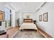 Inviting bedroom featuring hardwood floors, a cozy bed with decorative pillows, and natural light, creating a serene space at 105 Fillmore St # 209, Denver, CO 80206