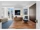 A contemporary bedroom features a large tv, hardwood flooring and natural light from the large window at 105 Fillmore St # 209, Denver, CO 80206
