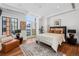 Bedroom features hardwood floors, bright natural light, and city views from a large window at 105 Fillmore St # 209, Denver, CO 80206