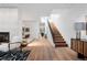 Bright foyer with hardwood floors, fireplace, and staircase leading to the upper level at 105 Fillmore St # 209, Denver, CO 80206