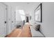 Bright hallway with hardwood floors, white walls, and a skylight, offering a clean and modern aesthetic at 105 Fillmore St # 209, Denver, CO 80206