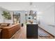 Bright, modern kitchen featuring an island, stainless steel hood, and hardwood floors, seamlessly flowing into the living area at 105 Fillmore St # 209, Denver, CO 80206