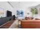 Spacious living room with modern furniture, large TV, hardwood floors, and stylish decor offers a comfortable living space at 105 Fillmore St # 209, Denver, CO 80206