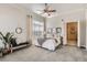 Bright bedroom with a ceiling fan, bench, mirror, neutral decor and an ensuite bathroom at 5677 S Park Pl # C111, Englewood, CO 80111