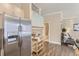 Spacious kitchen with stainless steel refrigerator, light wood cabinets, and an adjacent living area for easy entertaining at 5677 S Park Pl # C111, Englewood, CO 80111
