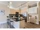 Well-equipped kitchen with a black countertop island, stainless steel appliances, and ample cabinet space at 5677 S Park Pl # C111, Englewood, CO 80111