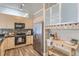 Modern kitchen featuring stainless steel appliances, light wood cabinets, and a convenient wine rack and storage at 5677 S Park Pl # C111, Englewood, CO 80111
