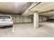 Underground parking garage with parking spaces and concrete pillars at 5677 S Park Pl # C111, Englewood, CO 80111