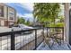 Outdoor patio with a small table and seating, overlooking the parking lot and green space at 5677 S Park Pl # C111, Englewood, CO 80111