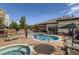Outdoor pool and hot tub with lounge chairs and umbrellas at 5677 S Park Pl # C111, Englewood, CO 80111