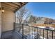 View from balcony of snowy parking lot with railing in foreground and neighborhood buildings in the background at 6021 Yarrow St # B13, Arvada, CO 80004