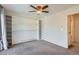 Bedroom boasts built-in shelving and a ceiling fan at 6021 Yarrow St # B13, Arvada, CO 80004