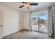 Bedroom features a ceiling fan and sliding glass doors to the balcony at 6021 Yarrow St # B13, Arvada, CO 80004