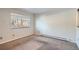 Bright empty bedroom with a large window for lots of natural light and neutral carpet at 6021 Yarrow St # B13, Arvada, CO 80004