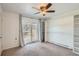 Bedroom includes built-in shelving and sliding glass doors to a balcony at 6021 Yarrow St # B13, Arvada, CO 80004