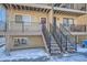 Exterior shot of the front entrances, showing the steps, railings, and design of the building at 6021 Yarrow St # B13, Arvada, CO 80004