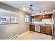 Kitchen with light-colored walls and cabinets, stainless steel appliances, and large windows for natural light at 6021 Yarrow St # B13, Arvada, CO 80004