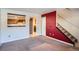 Open-concept living room with a view to the kitchen through a pass-through window and access to the staircase at 6021 Yarrow St # B13, Arvada, CO 80004