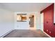 Bright living room with a pass-through window to the kitchen and open access to the kitchen and front hallway at 6021 Yarrow St # B13, Arvada, CO 80004