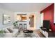 Bright living room featuring a modern sofa, stylish coffee table, and a pass-through to the adjacent kitchen at 6021 Yarrow St # B13, Arvada, CO 80004