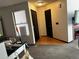 Entryway with wooden laminate flooring, two storage closets and a window at 1825 Kendall St # 205, Lakewood, CO 80214