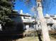 Exterior view of a townhome complex with balconies and a well-maintained lawn on a sunny day at 1825 Kendall St # 205, Lakewood, CO 80214