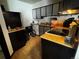 View of a kitchen featuring dark cabinetry and essential appliances at 1825 Kendall St # 205, Lakewood, CO 80214