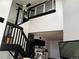 Living room featuring a fireplace, open staircase, and an attached kitchen, ready for your personal touches at 1825 Kendall St # 205, Lakewood, CO 80214