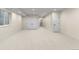 A spacious basement with a large window, carpeted floor, and multiple white doors at 2466 S Cherokee St, Denver, CO 80223