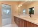Modern bathroom featuring a double vanity with wood cabinets and white countertop at 2466 S Cherokee St, Denver, CO 80223