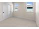 Neutral bedroom featuring two windows, neutral carpet, and a closet with sliding doors at 2466 S Cherokee St, Denver, CO 80223