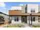 Modern home featuring multi-tone exterior, with a covered porch and decorative stone landscaping at 2466 S Cherokee St, Denver, CO 80223