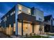 Modern home features stylish lighting, a covered porch, and multi-tone exterior at 2466 S Cherokee St, Denver, CO 80223