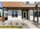 Contemporary home featuring a stylish front porch with natural wood and tiled accents at 2466 S Cherokee St, Denver, CO 80223