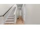 Bright hallway featuring wood floors, and a staircase with black railing at 2466 S Cherokee St, Denver, CO 80223