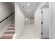 Hallway with carpeted floor, recessed lighting, staircase, and closed door with black hardware at 2466 S Cherokee St, Denver, CO 80223