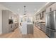 Updated kitchen with stainless steel appliances, a large island, and modern cabinetry at 2466 S Cherokee St, Denver, CO 80223