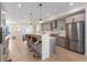 Modern kitchen with stainless steel appliances and bar seating at 2466 S Cherokee St, Denver, CO 80223