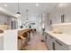 Open kitchen with island, bar seating, and stainless steel appliances at 2466 S Cherokee St, Denver, CO 80223