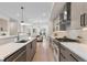 Spacious kitchen with an island, stainless steel appliances, and hardwood floors throughout at 2466 S Cherokee St, Denver, CO 80223