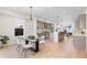 Open-concept kitchen with modern gray cabinets, stainless steel appliances, and hardwood flooring at 2466 S Cherokee St, Denver, CO 80223