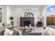 Cozy living room with fireplace, gray couch, and open door to outside at 2466 S Cherokee St, Denver, CO 80223