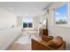 Bright living room featuring a stylish accent chair and a sliding door to access a cozy outdoor balcony at 2466 S Cherokee St, Denver, CO 80223