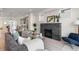 Bright living room boasts fireplace, gray couch and open floor plan at 2466 S Cherokee St, Denver, CO 80223
